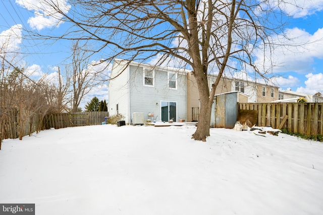 view of snow covered rear of property