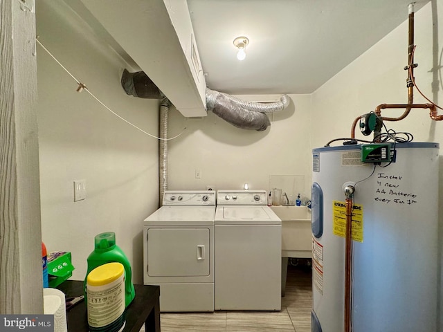 laundry area featuring washer and dryer, sink, and electric water heater