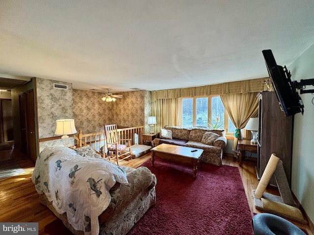 living room featuring ceiling fan and wood-type flooring