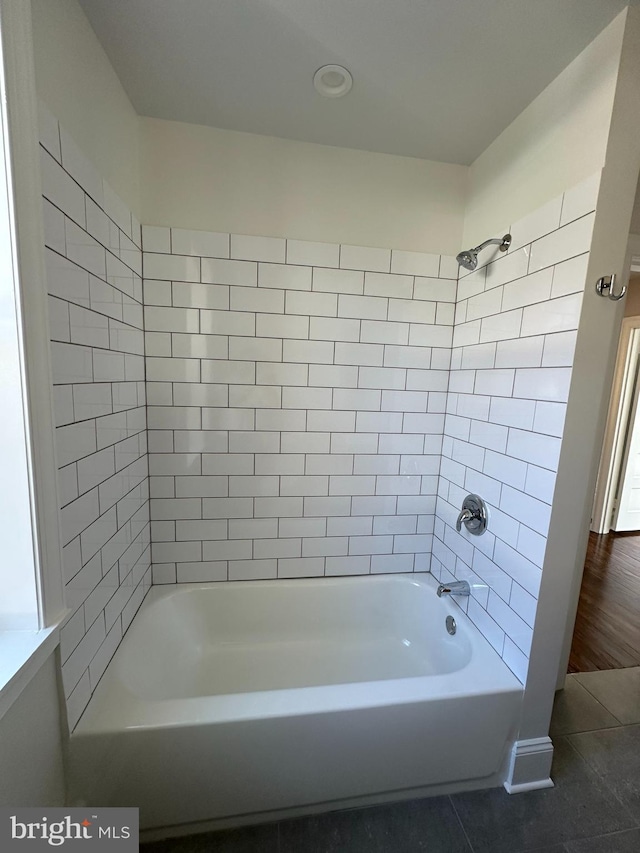 bathroom with tile patterned floors and tiled shower / bath