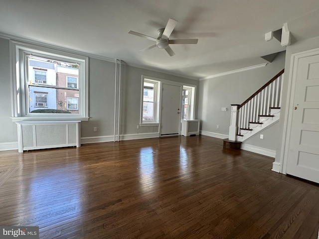 entrance foyer with ceiling fan, radiator heating unit, dark wood-type flooring, and ornamental molding