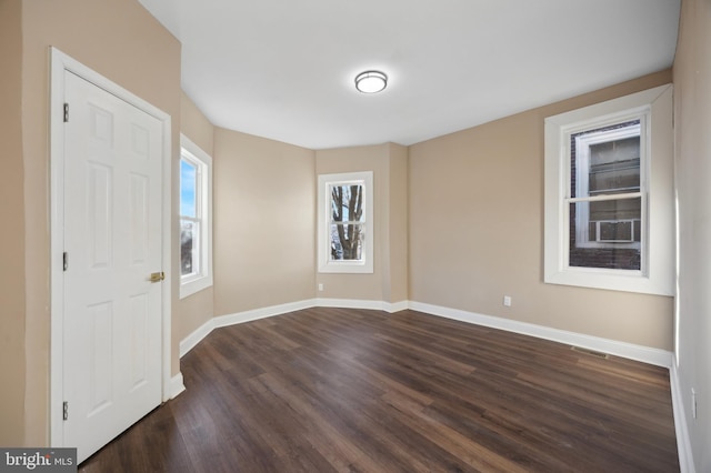 unfurnished room featuring dark hardwood / wood-style floors