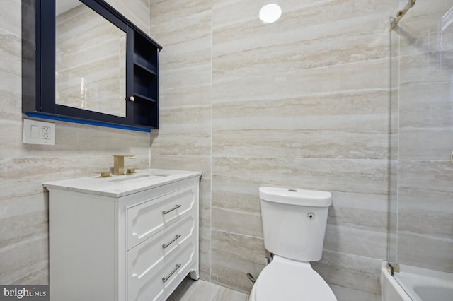 full bathroom featuring toilet, vanity, and shower / washtub combination