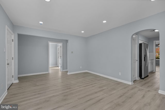 spare room featuring light wood-type flooring