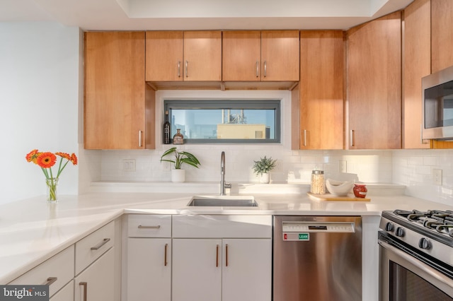 kitchen featuring backsplash, sink, white cabinetry, and stainless steel appliances