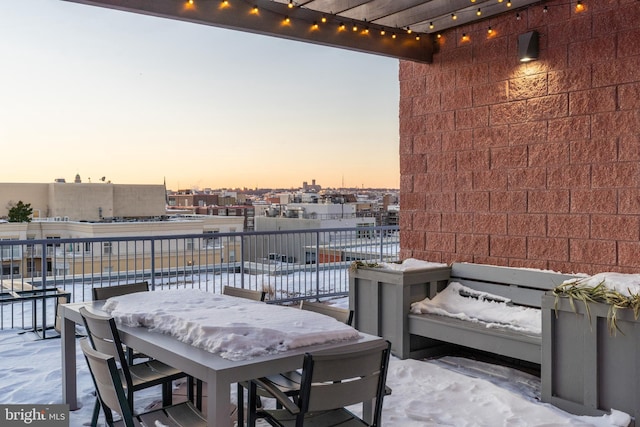 patio terrace at dusk featuring a balcony