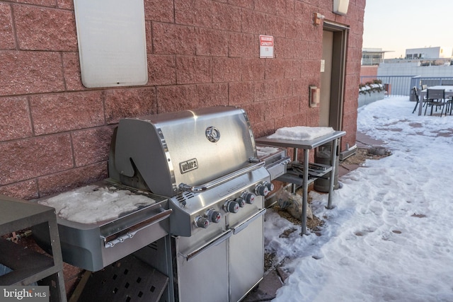 snow covered patio with grilling area