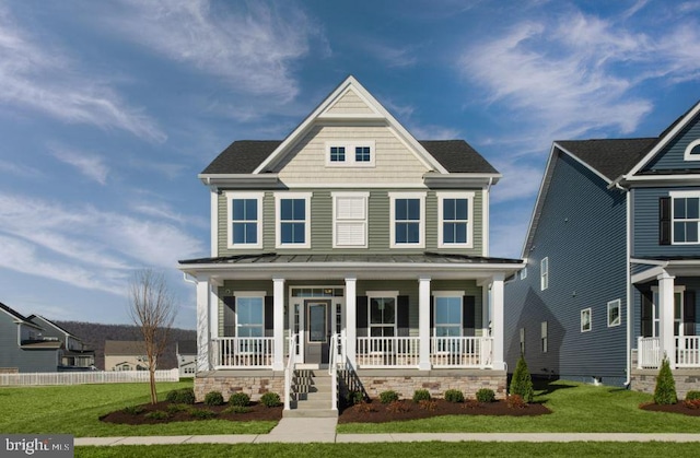 view of front of house with covered porch and a front yard