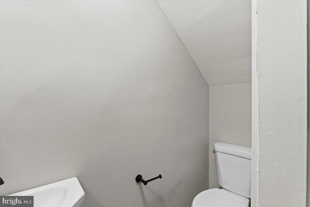 bathroom with vaulted ceiling and toilet