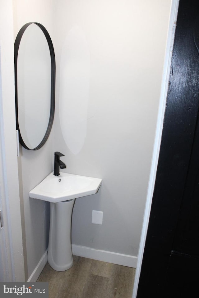 bathroom with wood finished floors and baseboards