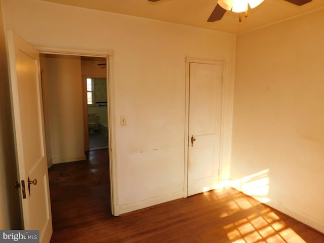 unfurnished bedroom with dark wood-type flooring