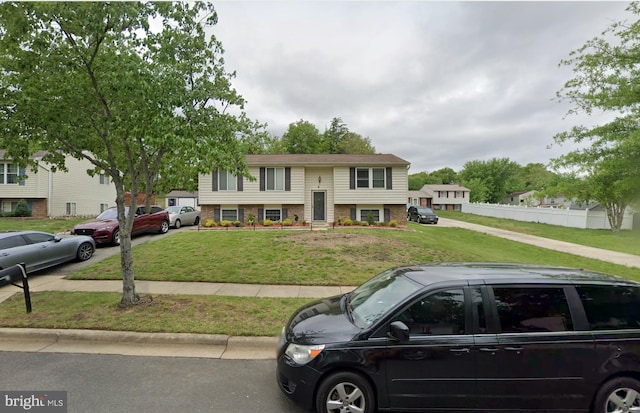 raised ranch with a front yard