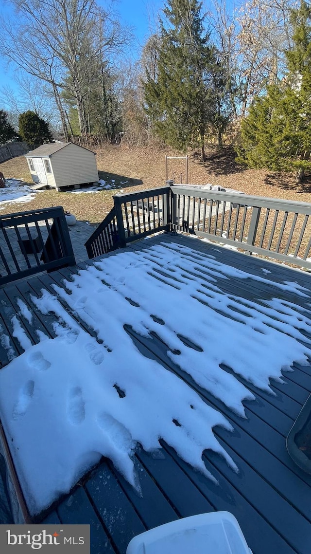 snow covered deck with a storage unit