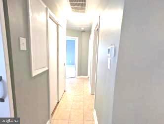 hallway with light tile patterned flooring