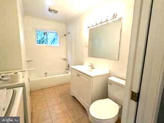 bathroom featuring tile patterned floors, vanity, and toilet