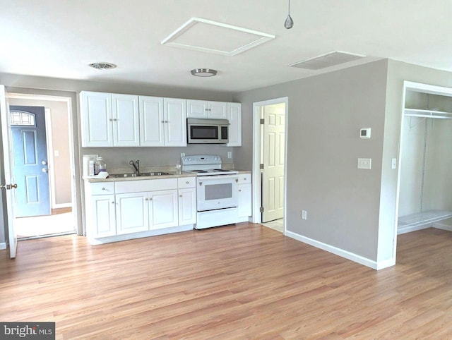 kitchen featuring sink, white cabinets, light wood-type flooring, and white electric range