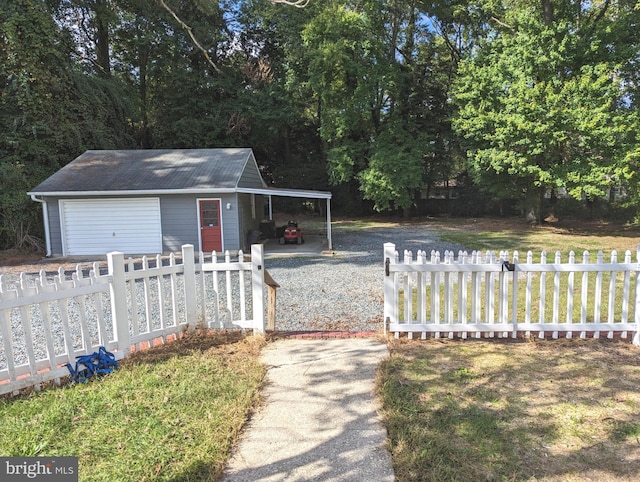 view of front facade with a front lawn, an outdoor structure, and a carport