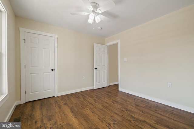 unfurnished bedroom featuring dark hardwood / wood-style floors and ceiling fan