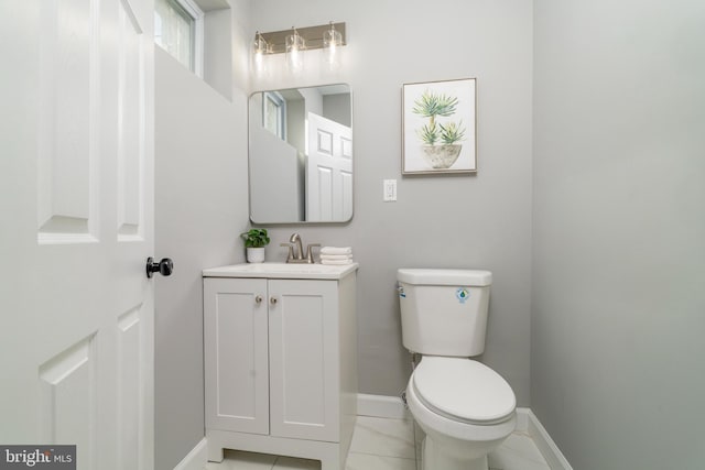 bathroom featuring vanity, toilet, and tile patterned flooring