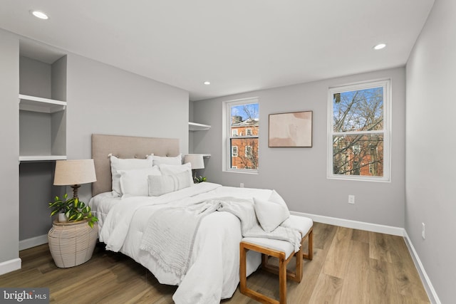 bedroom featuring hardwood / wood-style flooring and multiple windows