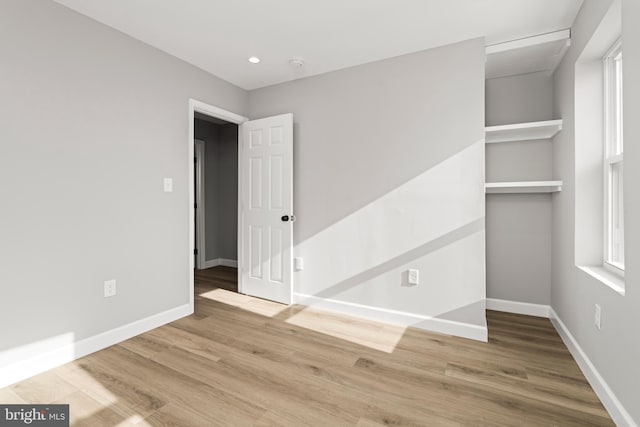 unfurnished bedroom featuring hardwood / wood-style floors and a closet