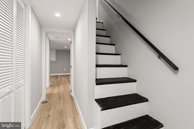 stairs featuring hardwood / wood-style floors