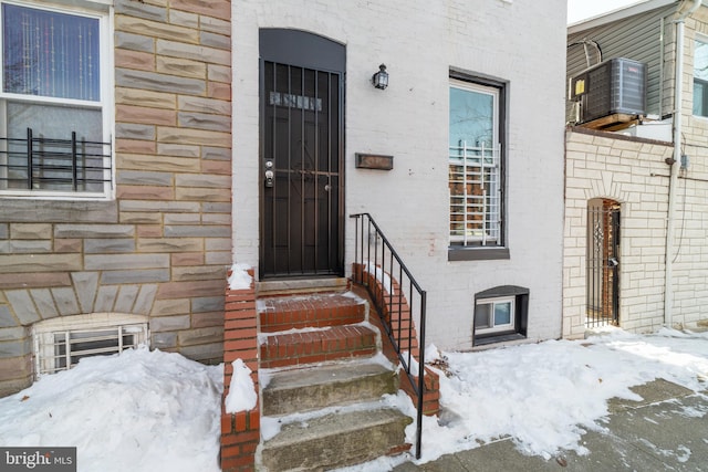 view of snow covered property entrance