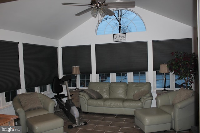 living room with ceiling fan and high vaulted ceiling