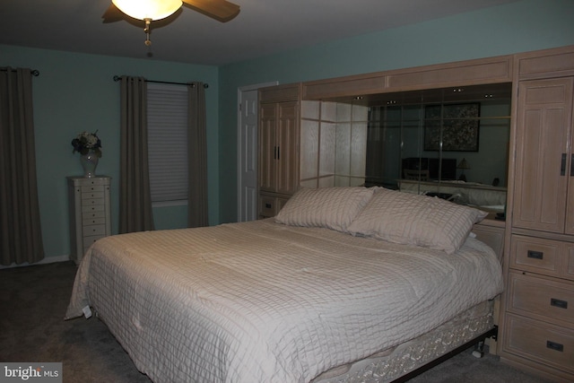 bedroom featuring ceiling fan and dark carpet