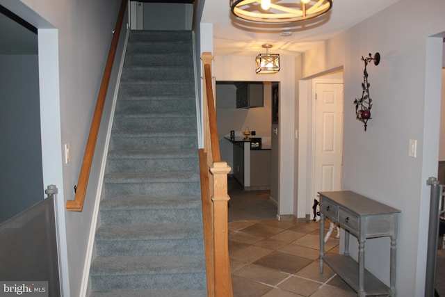 stairway with tile patterned floors