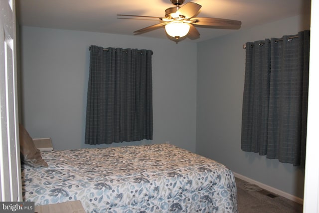 bedroom featuring ceiling fan and carpet