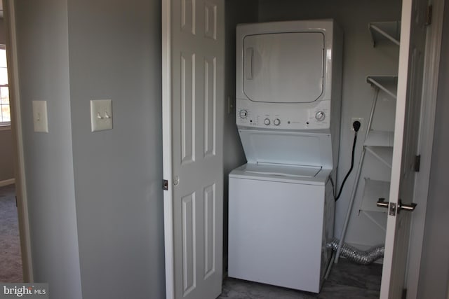 washroom featuring stacked washing maching and dryer