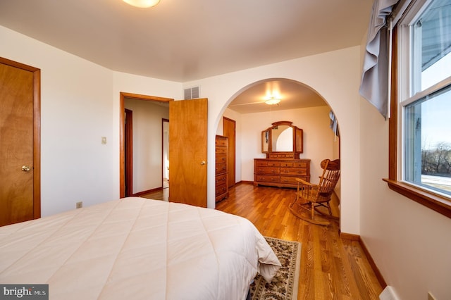 bedroom with hardwood / wood-style flooring