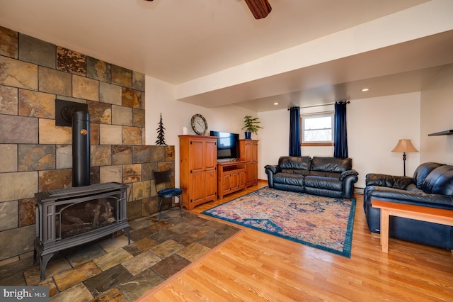 living room featuring a wood stove and hardwood / wood-style floors