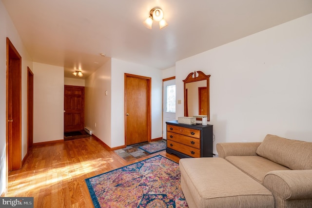 living area featuring light wood-type flooring and baseboard heating