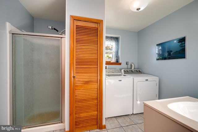 bathroom featuring tile patterned floors, a shower with shower door, and independent washer and dryer