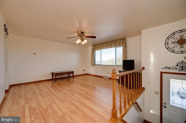 living room featuring ceiling fan and light hardwood / wood-style flooring