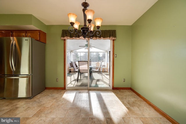 unfurnished dining area featuring ceiling fan with notable chandelier