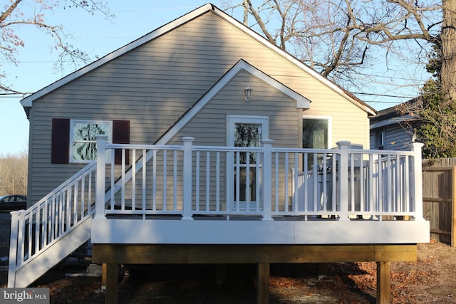 rear view of house featuring a wooden deck