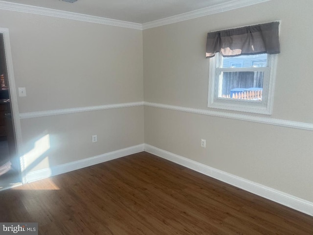 empty room with dark wood-type flooring and ornamental molding