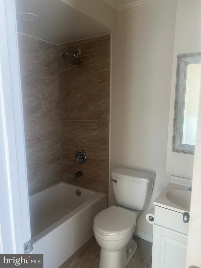 full bathroom featuring vanity, tiled shower / bath combo, and toilet