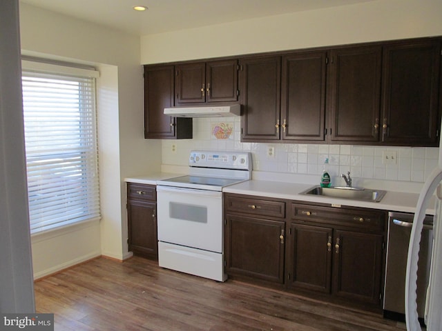 kitchen featuring sink, dishwasher, white electric stove, dark brown cabinetry, and dark hardwood / wood-style flooring