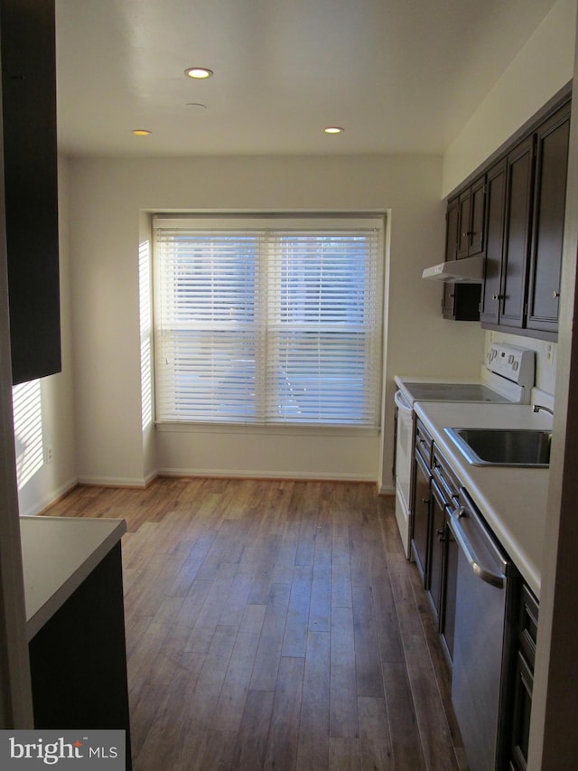 kitchen with dishwasher, sink, electric range, wood-type flooring, and dark brown cabinetry