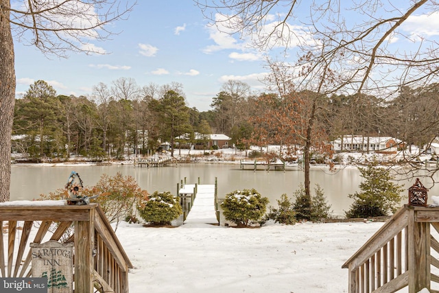 snowy yard featuring a water view