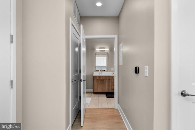 corridor with light hardwood / wood-style floors