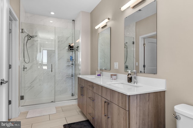 bathroom featuring vanity, toilet, and walk in shower