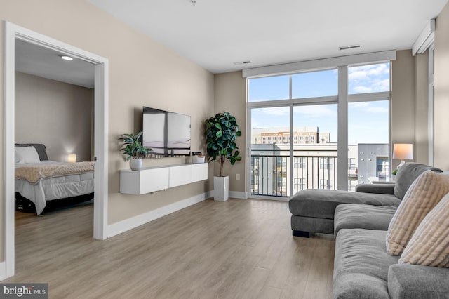 living room featuring hardwood / wood-style floors and a wall of windows