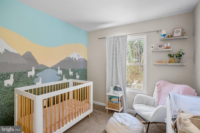 carpeted bedroom with a nursery area