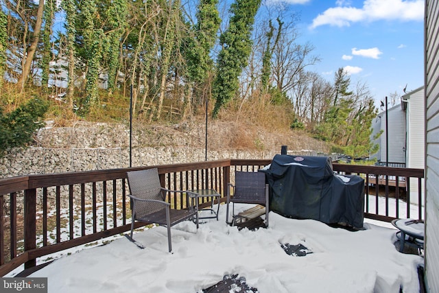 snow covered deck featuring area for grilling