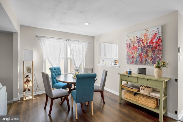 dining space with dark hardwood / wood-style floors